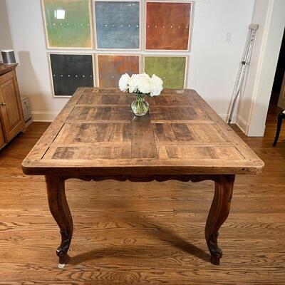 CUSTOM DINING TABLE | Old wood board top resting on a carved apron over cabriole legs, no apparent maker's mark; h. 29-1/4 x w. 68-3/4 x...