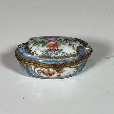 (9pc) PORCELAIN BOXES | Including a hand-painted Sevres box with gilt highlights and marked on the bottom, plus many Halcyon Days Enamels...