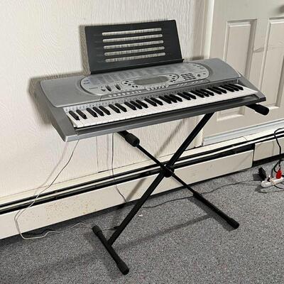 CASIO ELECTRIC KEYBOARD | Piano Keyboard with learning features- tested and works! On a folding stand; keyboard l. 37 in.