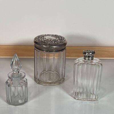 (3pc) SILVER & GLASS JARS | Including two jars with sterling silver lids decorated en repousse (lids stamped 