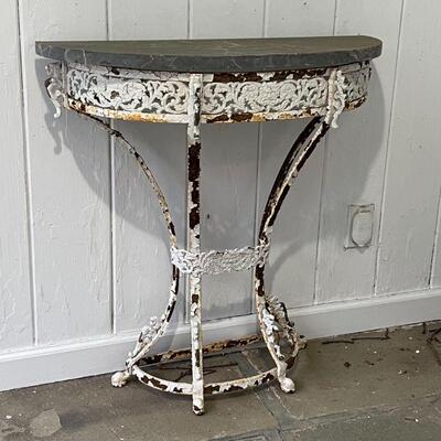 STONE TOP IRON SIDE TABLE | Demilune side table having a dark stone top over a white iron base with openwork scrolling acanthus apron; h....