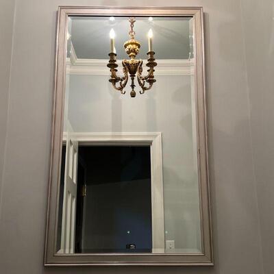 LARGE BEVELED MIRROR | Beveled glass wall mirror in a silvered frame; overall 48 x 28 in.
