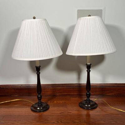PAIR WOOD TABLE LAMPS | Turned wood candlesticks mounted as lamps; overall h. 28-1/4 x dia. 14-1/2 in.