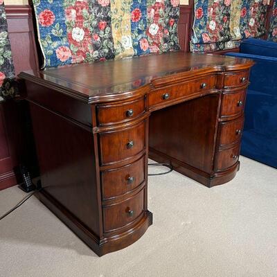 HOOKER FURNITURE DESK | An impressive looking kneehole desk with inset leather top and two banks of three drawers, center drawer front...