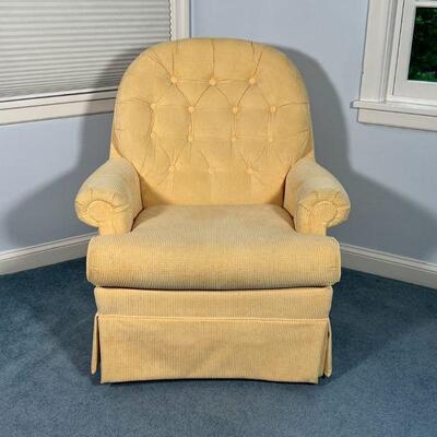 UPHOLSTERED ROCKING CHAIR | By Best Chairs Inc., with yellow soft textured upholstery, swivels and rocks; h. 40 x w. 33 x d. 31 in.