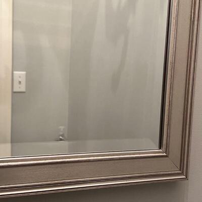 LARGE BEVELED MIRROR | Beveled glass wall mirror in a silvered frame; overall 48 x 28 in.