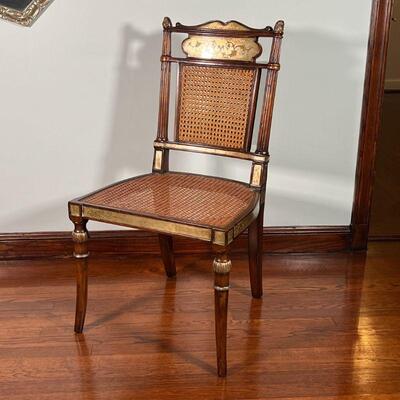 PAIR GILT CANED CHAIRS | English Regency style side chairs, carved with with gilt mirrored highlights and painted details, having caned...