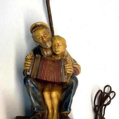 193. Man Teaching Boy to Play the Accordion Lamp Signed- RT 8/35