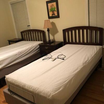 2 Twin Beds with headboards.  The bed in the forground has an adjustable platform.