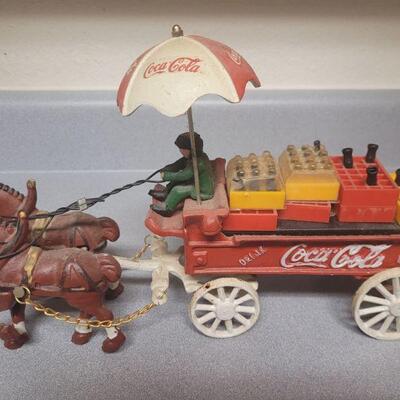 cast metal horses and cart hauling cases of Coke