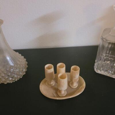 two glass decanters and a marble shot glass and tray set