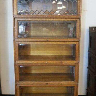 1012	LUNDSTROM 5 SECTION OAK BOOKCASE W/LEADED GLASS TOP & DRAWER AT BASE, APPROXIMATELY 33 IN X 13 I X 68 IN HIGH
