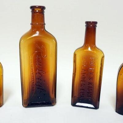 1223	LOT OF 4 ANTIQUE BOTTLES IN AMBER GLASS, TALLEST IS APPROXIMATELY 8 3/4 IN HIGH. RAWLEIGH'S AND FOLEY KIDNEY AND BLADDER CURE

