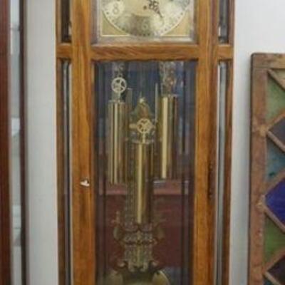1027	HOWARD MILLER OAK GRANDFATHERS CLOCK W/BEVELED GLASS DOORS & SIDES, MOON DIAL, APPROXIMATELY 24 1/4 IN X 14 IN X 84 IN HIGH
