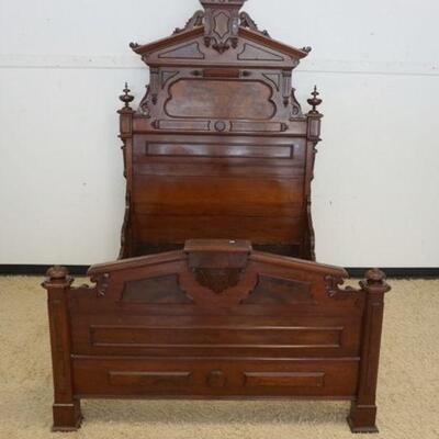 1031	ORNATE WALNUT VICTORIAN FULL SIZE HIGH BACK BED W/CARVED CREST, FINIALS, BURL INSET & APPLIED PANELS
