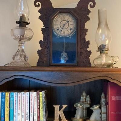 Bookshelf, oil lamps, mantle clock