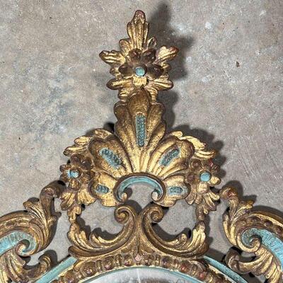 ANTIQUE PAINTED MIRROR  | Carved, gilt, and polychrome framed oval wall mirror with Rococo decorations, h. 30 x 18 in.