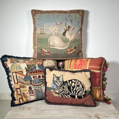 (4pc) NEEDLEPOINT PILLOWS | Various scenes, including a whale, a cat, and a townscape; largest 15 x 15 in.