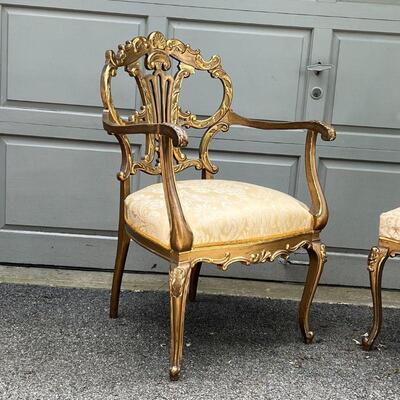 PAIR GILT CHAIRS | Fancy accent chairs, including an armchair (37 x 25 x 26 in.) and a side chair, each with highly carved backrests with...