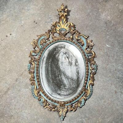 ANTIQUE PAINTED MIRROR  | Carved, gilt, and polychrome framed oval wall mirror with Rococo decorations, h. 30 x 18 in.