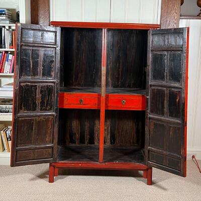 CHINESE LACQUERED CABINET | Red lacquered cabinet, with double doors opening to reveal two drawers between open shelves, with brass...