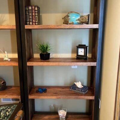 One of two matching bookcases. Natural wood trimmed with black iron.  Sold separately.