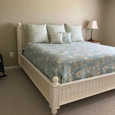 King size bed with white headboard, footboard and sideboards.  
