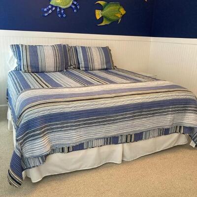 King size bed with bedding.  No headboard.  Like new.