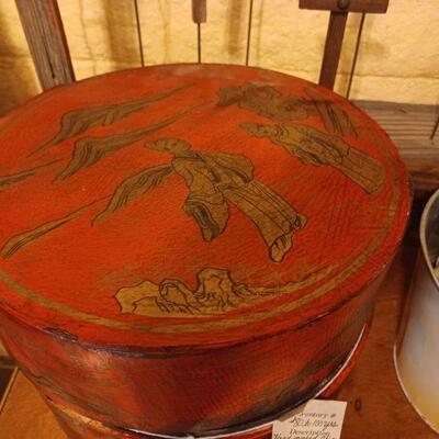 Antique leather-wrapped hat box over wood