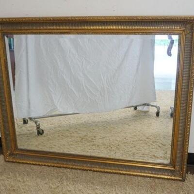 1093	HANGING MIRROR W/BEVELED EDGE IN ORNATE GILT FINISHED FRAME, APPROXIMATELY 48 IN X 38 IN
