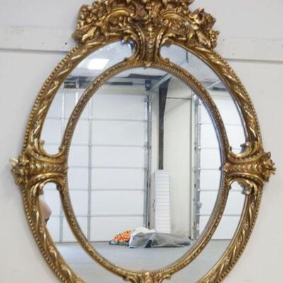 1086	LARGE ORNATE OVAL CAROLINA MIRROR IN COMPOSITE FRAME W/GILT FINISH, APPROXIMATELY 42 IN X 56 IN HIGH
