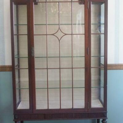 1104	IRISH MAHOGANY CURIO CABINET WITH INDIVIDAL GLASS PANED DOOR AND SIDES WITH ARCHED TOP AND BOTTOM EXTERIOR SHELF. APPROXIMATELY 42...
