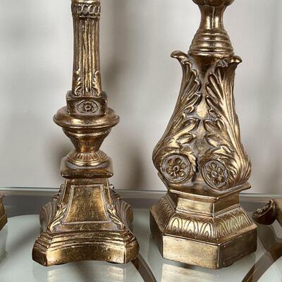 (5pc) GILT CANDLESTANDS | Gilt carved candle holders, with battery operated faux candles; tallest h. 22-3/4 in. (excluding candle),...