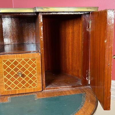 INLAID BAR CABINET | Inlaid wood with ormolu mounts, having a demilune superstructure with two cabinet doors centering a single drawer,...