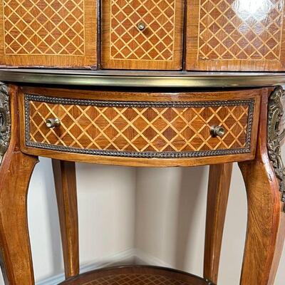 INLAID BAR CABINET | Inlaid wood with ormolu mounts, having a demilune superstructure with two cabinet doors centering a single drawer,...