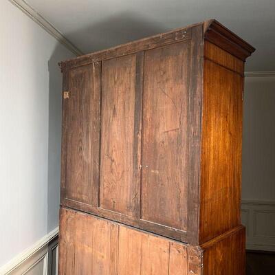 ANTIQUE LINEN PRESS | Possibly American, mahogany and walnut, having double cabinet doors with veneer arched panels, opening to reveal...