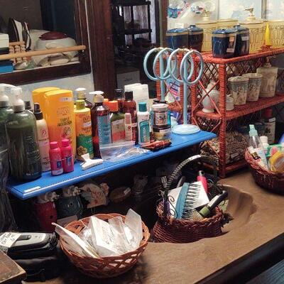 Bathroom is chock full of toiletries, perfumes and supplies for diabetics.