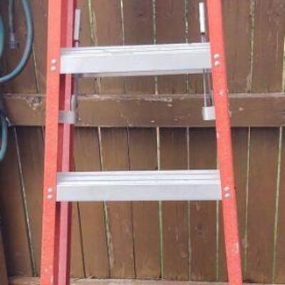 Three ladders at this sale, a Werner, a wooden and an aluminum extension ladder.