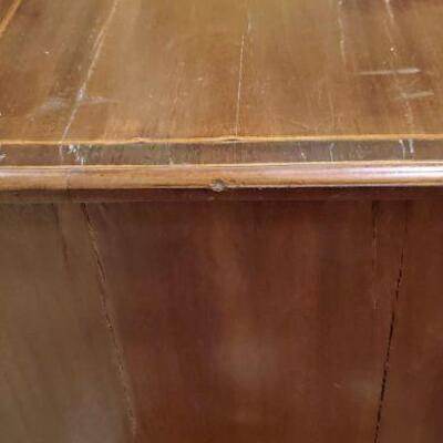 side of antique chest showing seams and splits in wood