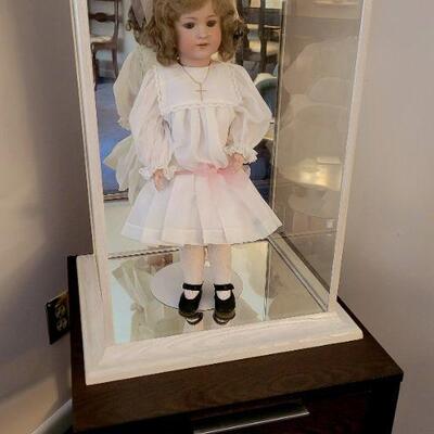 Doll in glass case