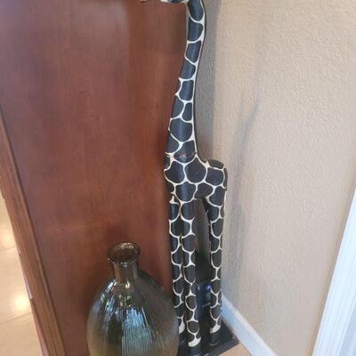Giraffe figurine and a bottle