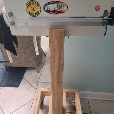 This is a bead roller in very good condition, it is mounted on a wheeled stand, includes the manual