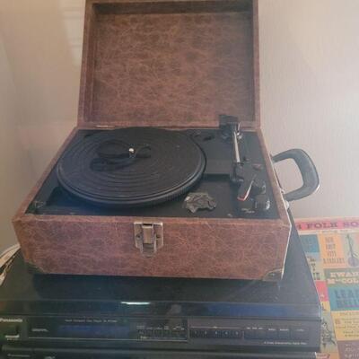 vintage record player, there are records including 45's