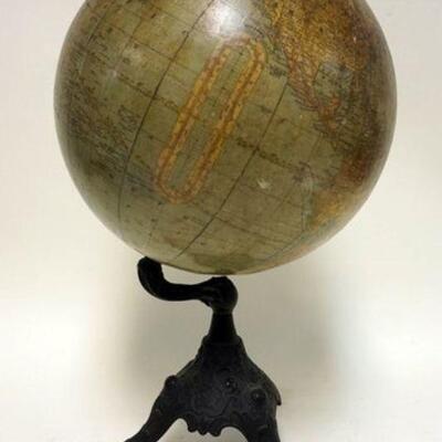 1073	RAND MCNALLY TERRESTRIAL GLOBE ON CLAW FOOT CAST IRON STAND, SOME LOSS TO TOP OF GLOBE, APPROXIMATELY 21 IN HIGH
