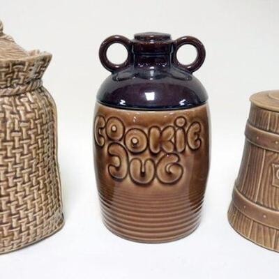 1084	LOT OF 3 COOKIE JARS, COVERED BASKET, *COOKIE JUG* AND *COOKIE CHURN*, TALLEST APPROXIMATELY 12 IN HIGH
