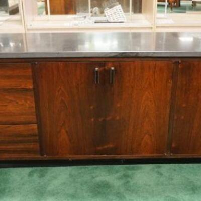 1174	MIDCENTURY MODERN 3 DRAWER 4 DOOR ROSEWOOD CREDENZA W/1 IN THICK SLATE TOP, APPROXIMATELY 78 IN C 19 IN X 26 IN HIGH
