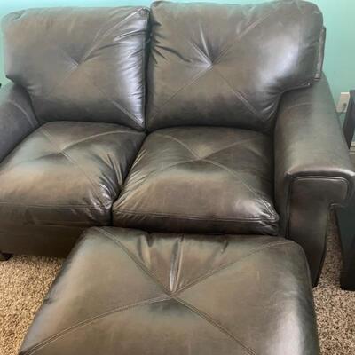 BLACK LEATHER LOVESEAT AND OTTOMAN  