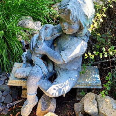 Yard bronze girl with puppy