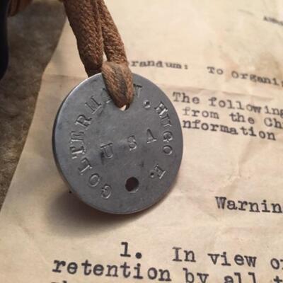 WWI dog tag attached to gas mask bag