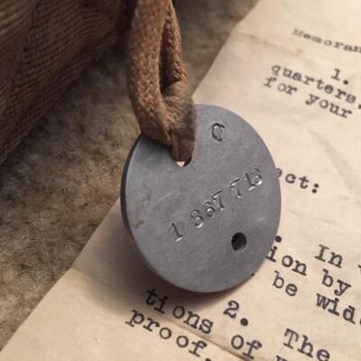 WWI dog tag attached to gas mask bag